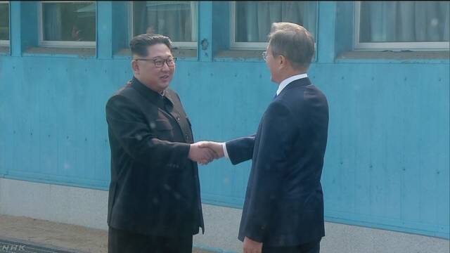 韓国と北朝鮮のトップが笑顔で握手をする
